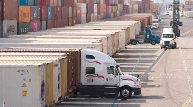 Trucks load and unload containers at Port of Long Beach. Under the new rule, ocean carriers must submit an invoice for detention and demurrage charges within 30 days instead of the previous 60 days. (Jae C. Hong/Associated Press)